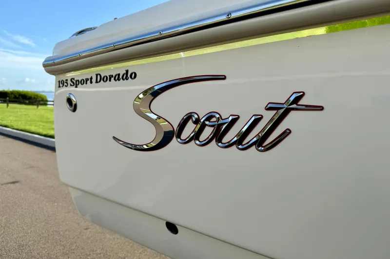 Slide: The Image of 2025 Scout 195 Sport Dorado boat logo on sleek white exterior. - 40