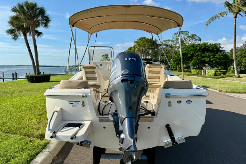 Slide: The Image of 2025 Scout 195 Sport Dorado boat with Yamaha engine, parked near waterfront. - 7