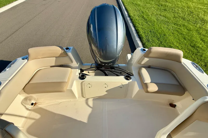 Slide: The Image of 2025 Scout 195 Sport Dorado boat interior with cushioned seating and outboard motor. - 9