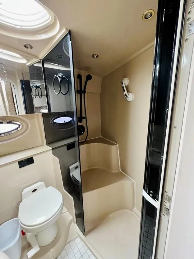 Slide: The Image of 2000 Cruisers Yachts 3772 Express bathroom with shower, toilet, and modern fixtures. - 12