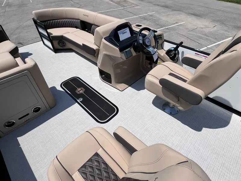 Slide: The Image of 2025 Harris Sunliner 230 boat interior with beige seating and modern dashboard. - 14