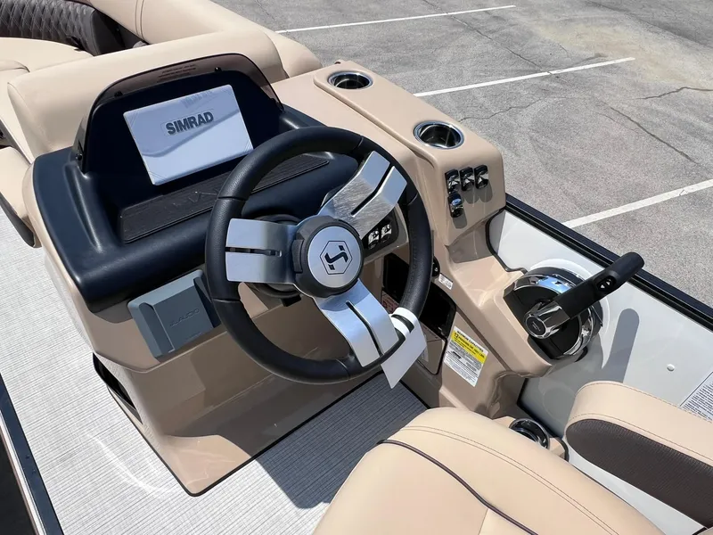 Slide: The Image of 2025 Harris Sunliner 230 boat dashboard with steering wheel and Simrad display. - 15