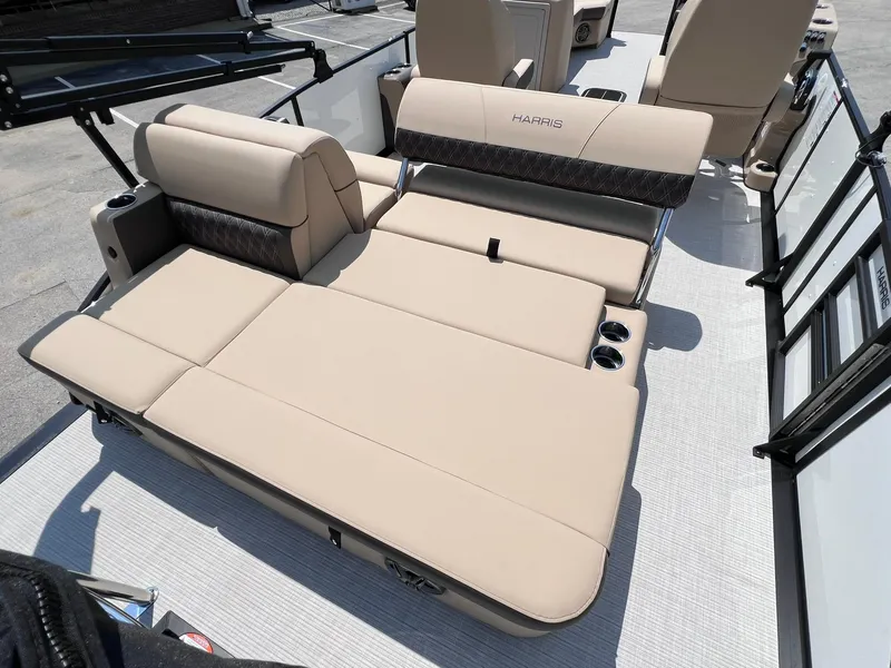 Slide: The Image of 2025 Harris Sunliner 230 boat interior with beige seating and cup holders. - 20