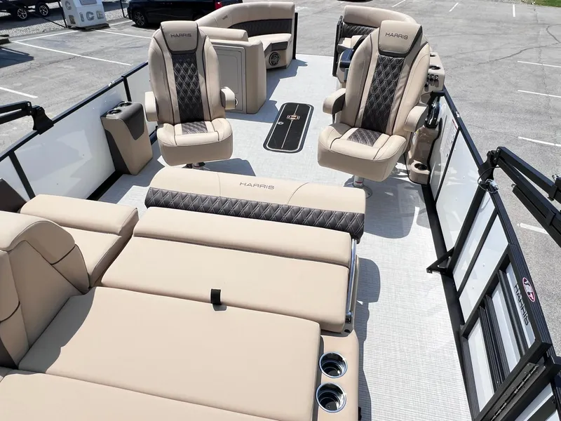 Slide: The Image of 2025 Harris Sunliner 230 interior with luxurious seating and modern design in a parking lot. - 22