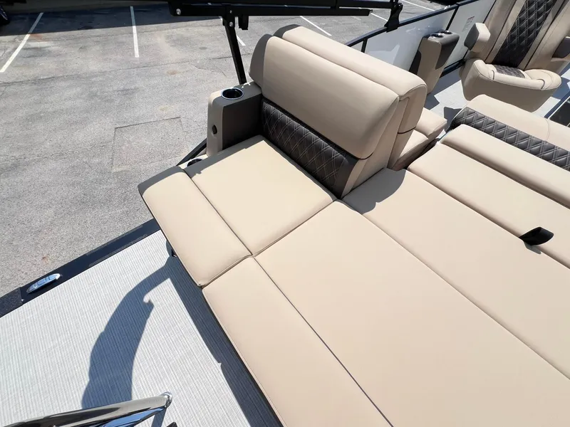 Slide: The Image of 2025 Harris Sunliner 230 boat with beige seating and cup holder on deck. - 23