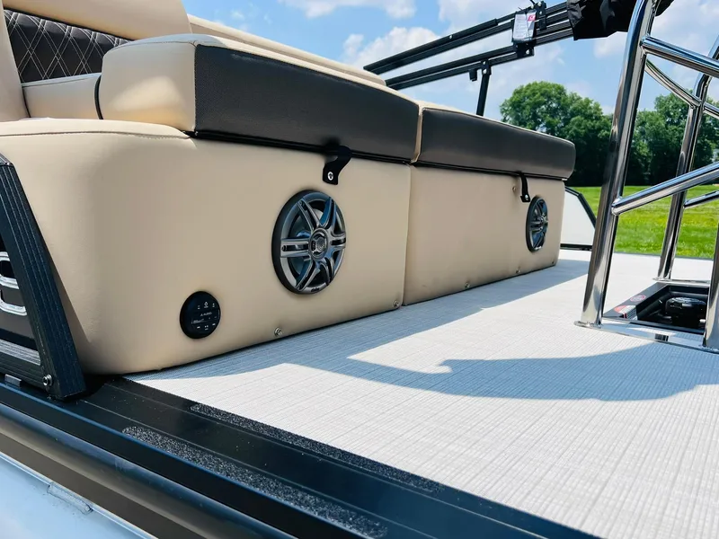 Slide: The Image of 2025 Harris Sunliner 230 boat interior with beige seating and built-in speakers. - 28