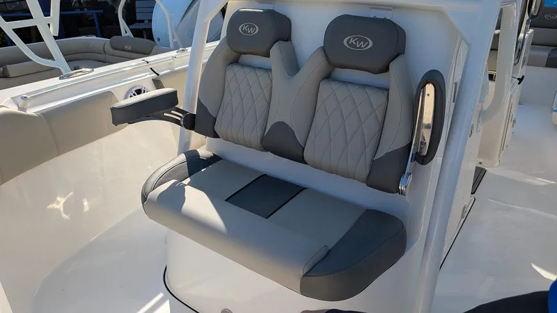 Slide: The Image of 2025 Key West 263 FS boat seating with gray cushioned seats and armrests. - 11