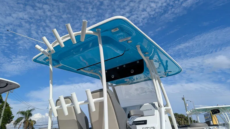 Slide: The Image of 2025 Key West 263 FS boat with blue T-top under a clear sky. - 14