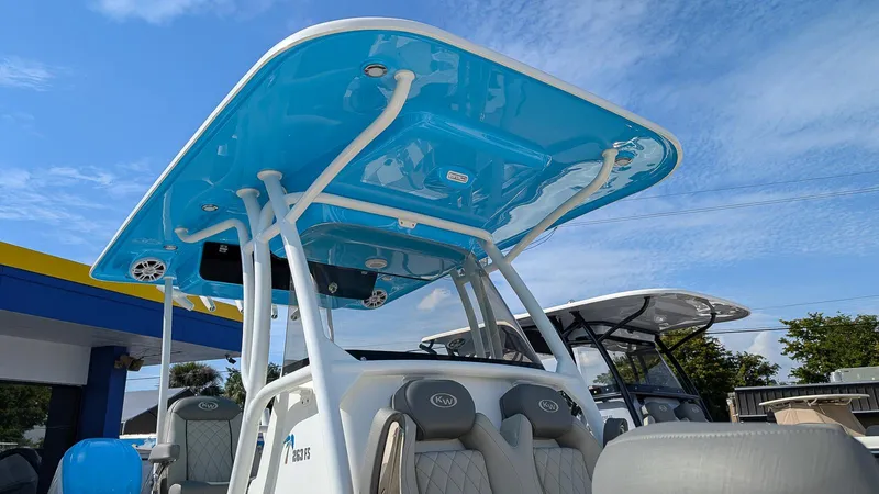 Slide: The Image of 2025 Key West 263 FS boat with blue T-top and cushioned seating. - 15