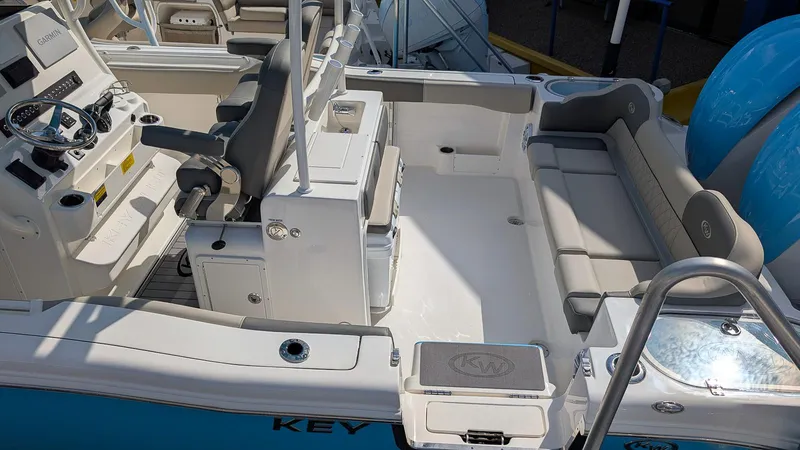 Slide: The Image of 2025 Key West 263 FS boat interior with seating and control console. - 4