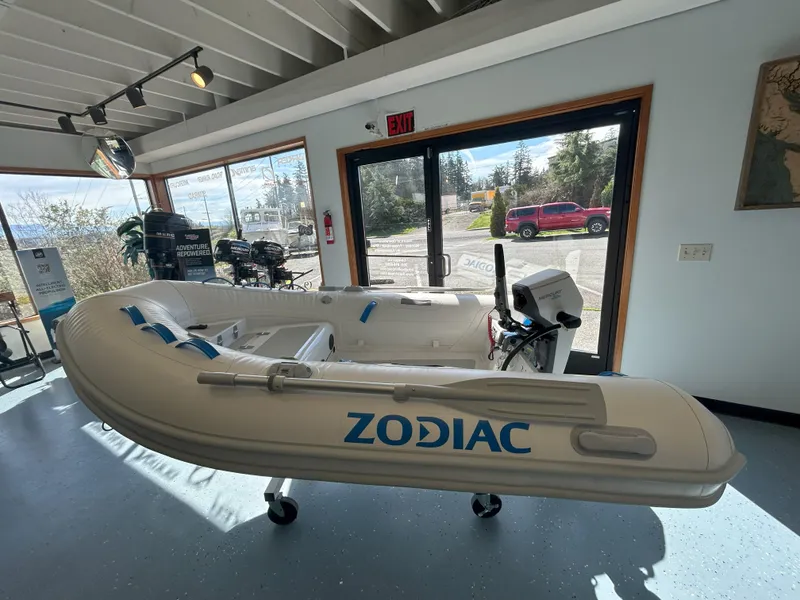 Slide: The Image of 2024 Zodiac Nomad 3.1 RIB Alu inflatable boat displayed indoors, showcasing sleek design. - 11