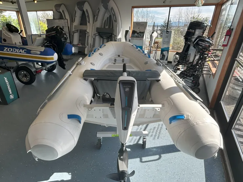 Slide: The Image of 2024 Zodiac Nomad 3.1 RIB Alu inflatable boat displayed in showroom with outboard motors. - 15