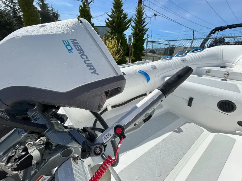 Slide: The Image of 2024 Zodiac Nomad 3.1 RIB Alu with Mercury 20E outboard motor, close-up view. - 16