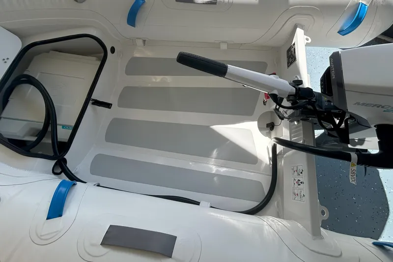 Slide: The Image of 2024 Zodiac Nomad 3.1 RIB Alu interior with motor, showcasing durable design and functionality. - 4