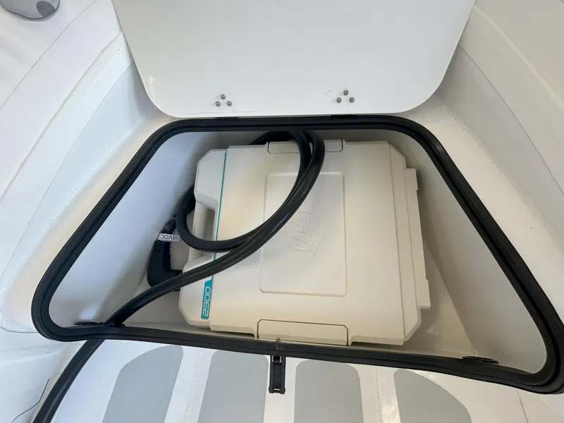 Slide: The Image of 2024 Zodiac Nomad 3.1 RIB Alu storage compartment with equipment inside. - 5