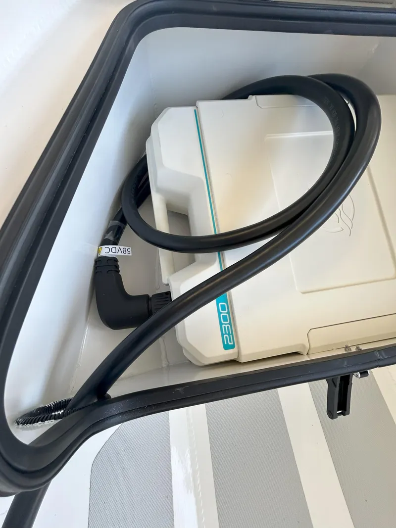 Slide: The Image of Storage compartment in 2024 Zodiac Nomad 3.1 RIB Alu with coiled cable. - 6