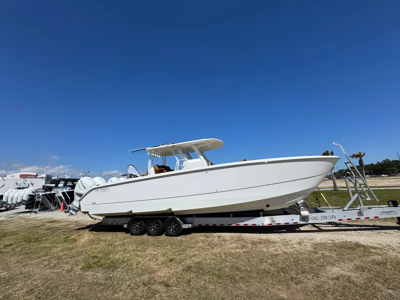 Slide: The Image of 2023 Invincible 37 Catamaran on trailer under clear blue sky. - 12