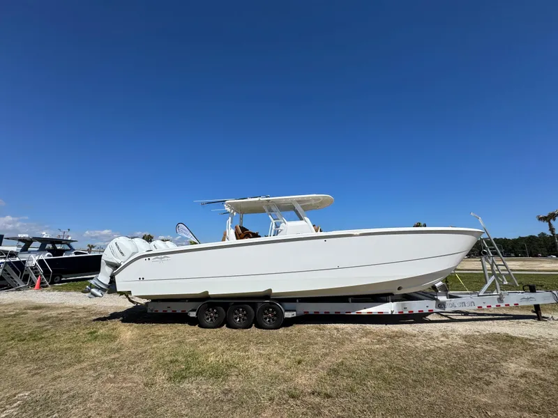 Slide: The Image of 2023 Invincible 37 Catamaran on trailer under clear blue sky. - 13