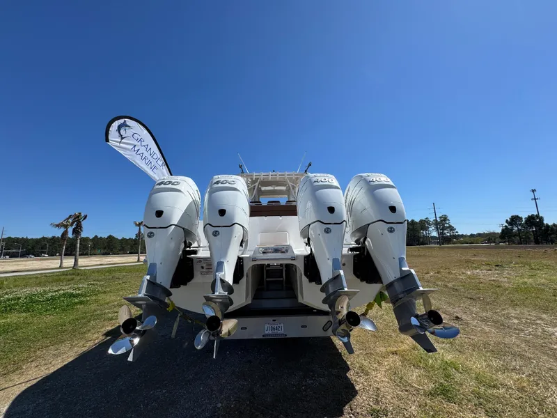 Slide: The Image of 2023 Invincible 37 Catamaran with four powerful outboard engines, displayed outdoors. - 19