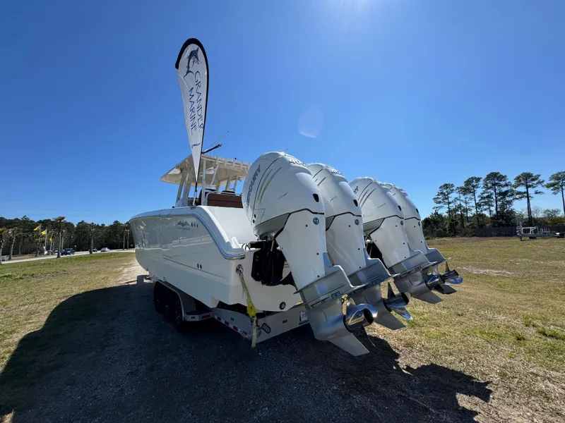 Slide: The Image of 2023 Invincible 37 Catamaran with triple outboard engines on display outdoors. - 20