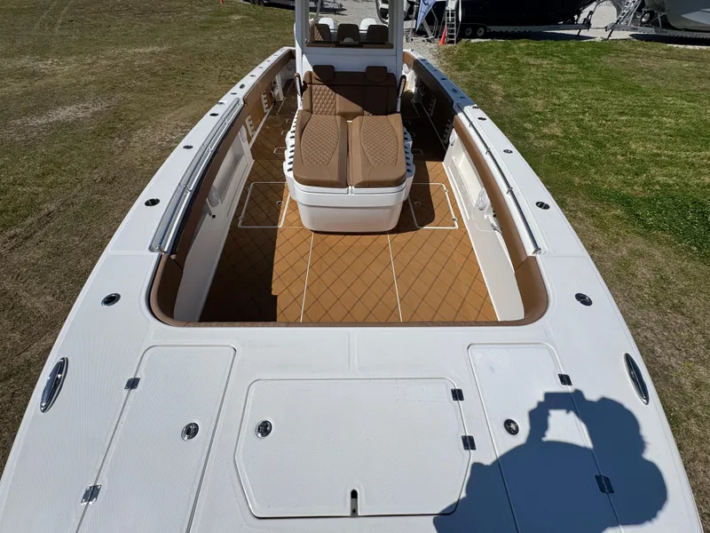 Slide: The Image of 2023 Invincible 37 Catamaran with spacious deck and seating, showcased on grass. - 22