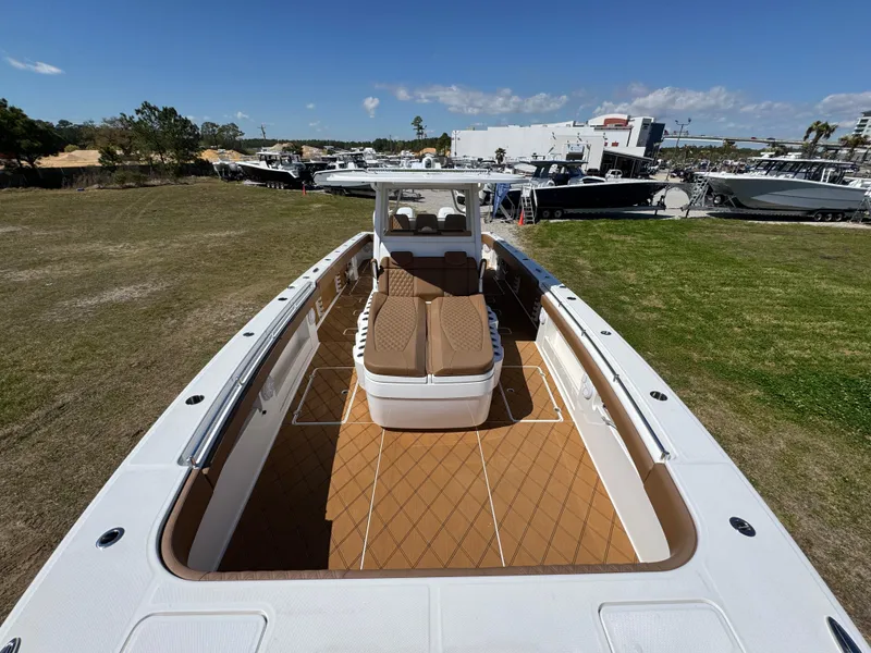 Slide: The Image of 2023 Invincible 37 Catamaran with spacious deck and seating, displayed outdoors. - 23