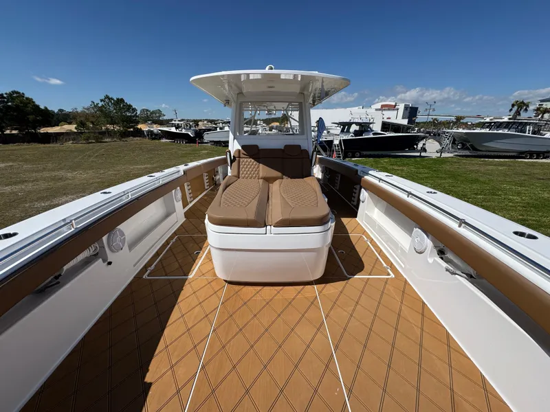 Slide: The Image of 2023 Invincible 37 Catamaran with spacious deck and comfortable seating under clear skies. - 24