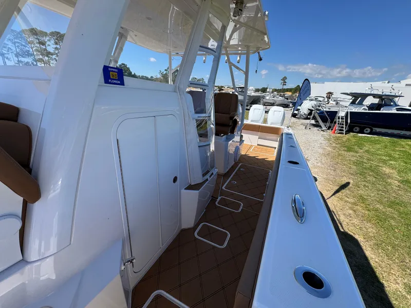 Slide: The Image of 2023 Invincible 37 Catamaran, sleek deck view, docked outdoors under clear sky. - 27