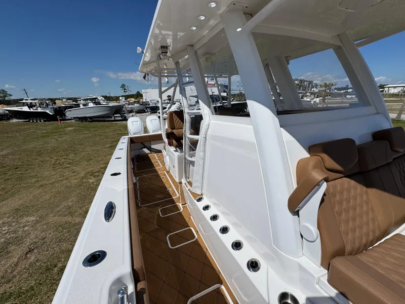 Slide: The Image of 2023 Invincible 37 Catamaran with sleek design and luxurious seating on display outdoors. - 28