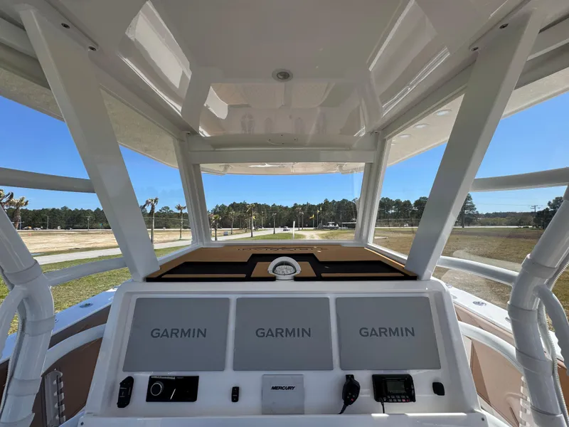 Slide: The Image of 2023 Invincible 37 Catamaran helm with Garmin displays and Mercury controls. - 31