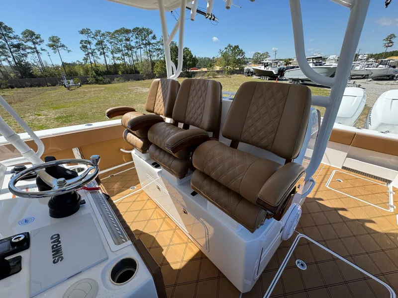 Slide: The Image of 2023 Invincible 37 Catamaran helm with luxurious tan seating and modern controls. - 32