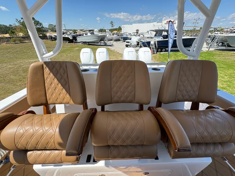 Slide: The Image of Luxurious seating on 2023 Invincible 37 Catamaran, featuring tan leather upholstery and diamond stitching. - 33