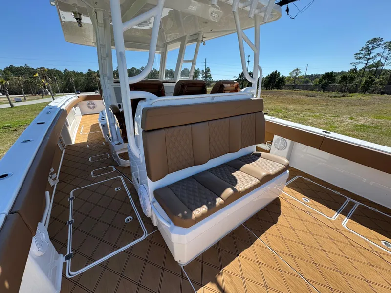 Slide: The Image of 2023 Invincible 37 Catamaran interior with brown seating and deck, showcasing luxury and comfort. - 34