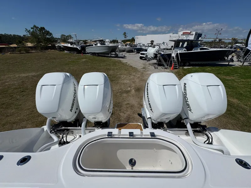 Slide: The Image of 2023 Invincible 37 Catamaran with four powerful outboard engines, docked in a marina. - 39