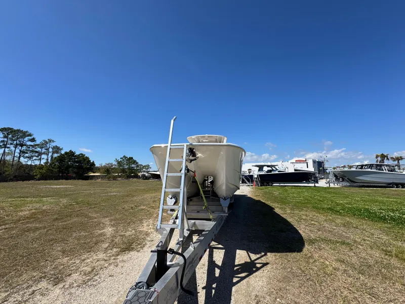 Slide: The Image of 2023 Invincible 37 Catamaran on trailer under clear blue sky. - 8