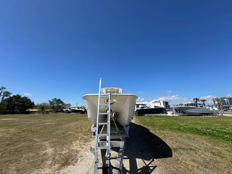 Slide: The Image of 2023 Invincible 37 Catamaran on trailer under clear blue sky. - 9