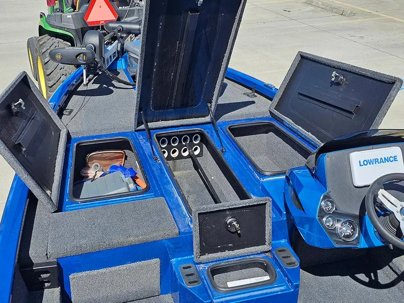 Slide: The Image of 2022 Vexus AVX1880 boat interior with open storage compartments and Lowrance electronics. - 17