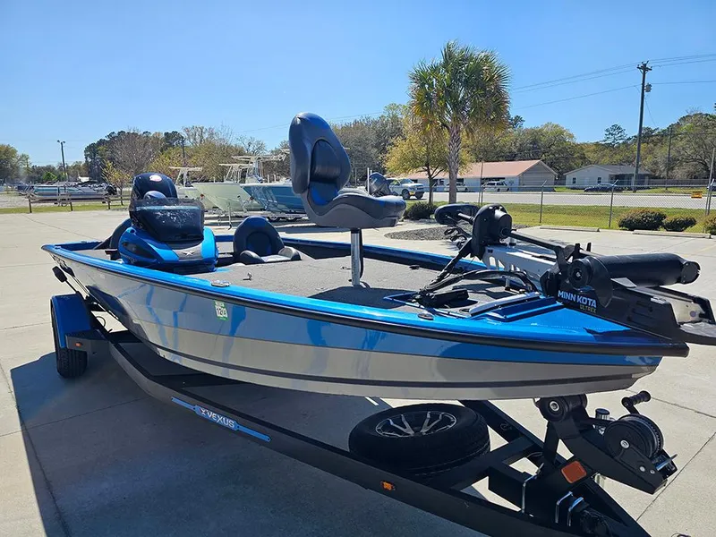 Slide: The Image of 2022 Vexus AVX1880 boat in blue, parked on a trailer in a sunny outdoor setting. - 5