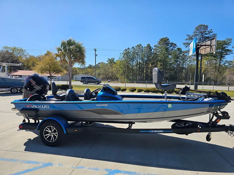 Slide: The Image of 2022 Vexus AVX1880 boat on trailer, blue and gray, parked outdoors. - 6