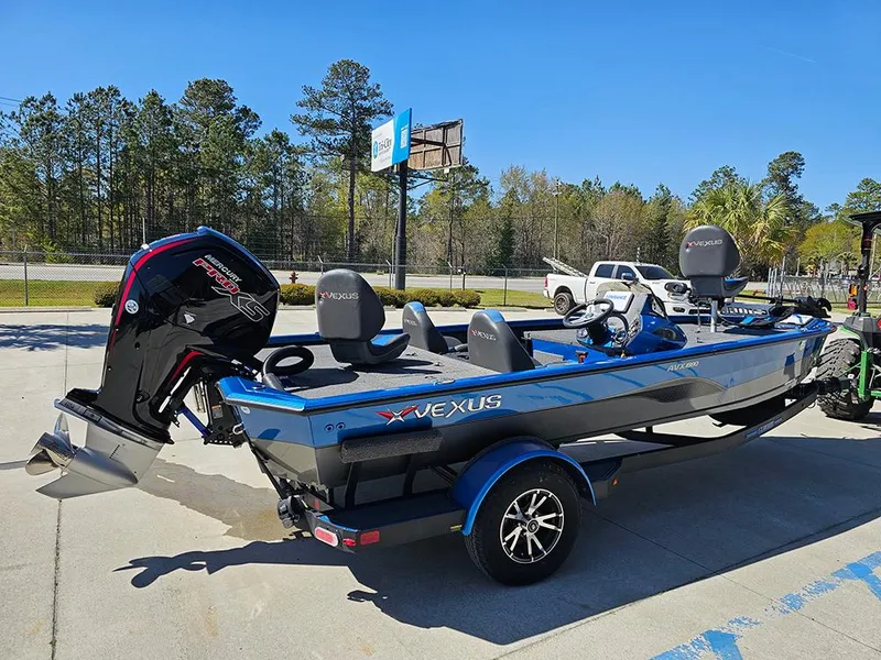 Slide: The Image of 2022 Vexus AVX1880 boat with outboard motor, parked outdoors on a sunny day. - 7
