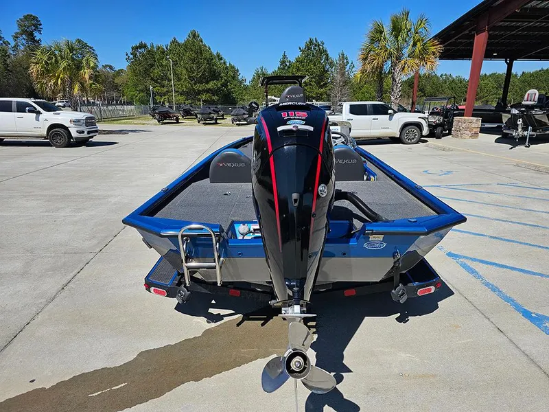 Slide: The Image of 2022 Vexus AVX1880 boat with outboard motor, parked outdoors on concrete. - 8