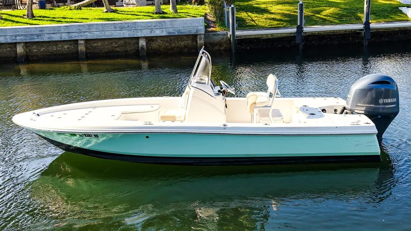 Slide: The Image of 2016 Robalo 206 Cayman boat on calm water, featuring a sleek design and Yamaha outboard motor. - 1