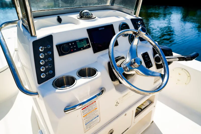 Slide: The Image of 2016 Robalo 206 Cayman boat dashboard with steering wheel and control panel. - 10