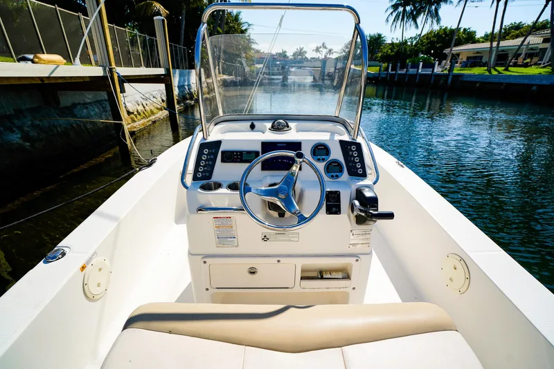 Slide: The Image of 2016 Robalo 206 Cayman boat interior with steering wheel, console, and waterway view. - 11