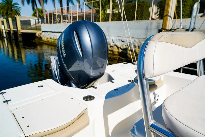 Slide: The Image of 2016 Robalo 206 Cayman boat with Yamaha engine, docked near palm trees. - 15