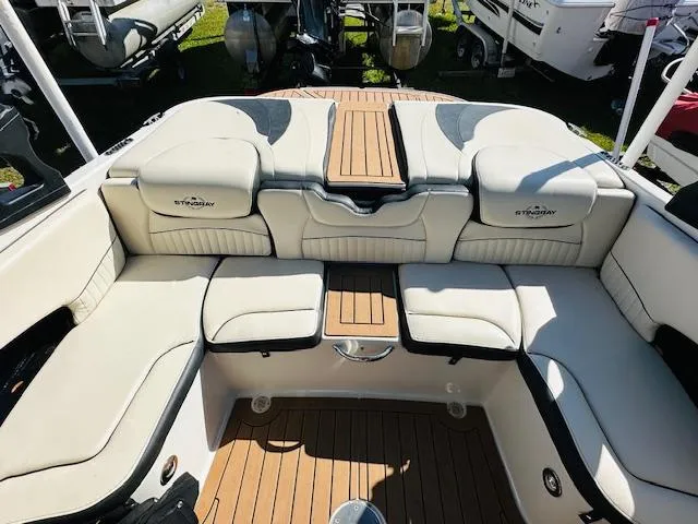 Slide: The Image of 2021 Stingray 225 SE boat interior with plush seating and teak flooring. - 10