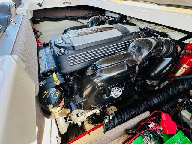 Slide: The Image of Engine compartment of a 2021 Stingray 225 SE boat, showcasing detailed mechanical components. - 17