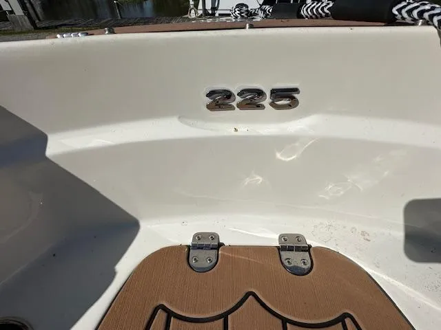 Slide: The Image of 2021 Stingray 225 SE boat interior with model number and wooden deck detail. - 21