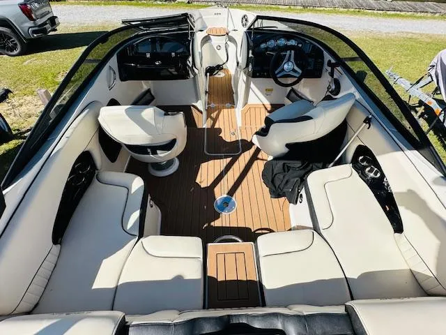 Slide: The Image of 2021 Stingray 225 SE boat interior with luxurious seating and modern dashboard. - 9