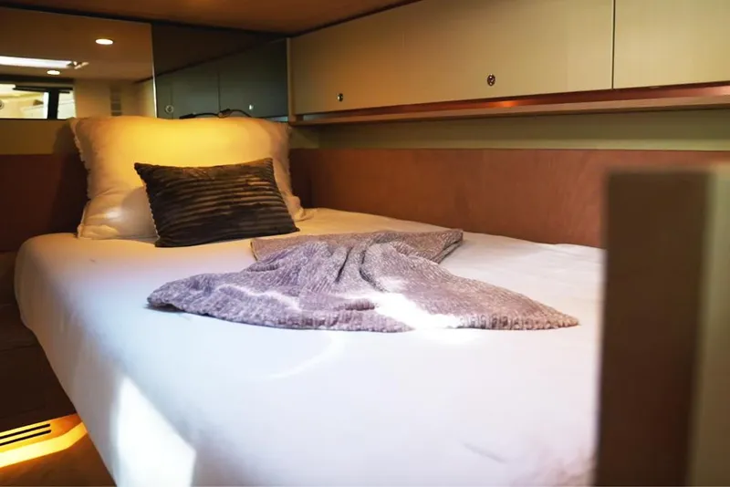 Slide: The Image of Cozy cabin interior of 2025 Waterdream California 52XT yacht with bed and soft lighting. - 20